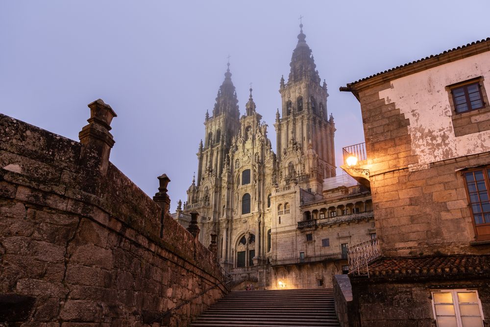 Santiago de Compostela Cathedral view at misty foggy night after rain. Cathedral of Saint James pilgrimage. Galicia, Spain