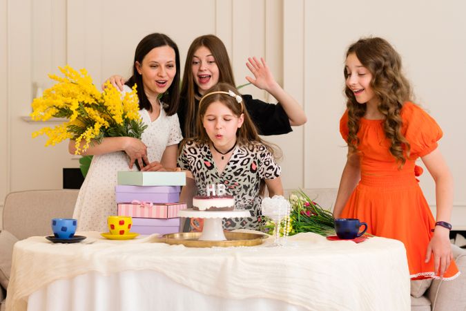 Family and friends celebrating birthday with cake...