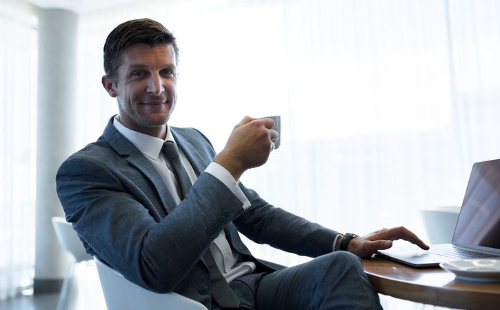 Businessman having a coffee break at office