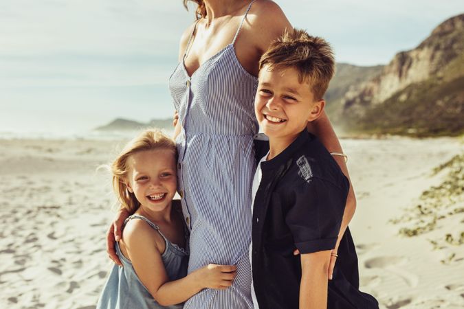 Boy and girl with their mother on the beach