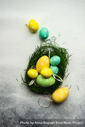 Easter festive card concept with green basket of pastel egg decorations 5qkPKp