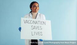Vaccination saves lives banner in hands of a female healthcare professional bEKRA5