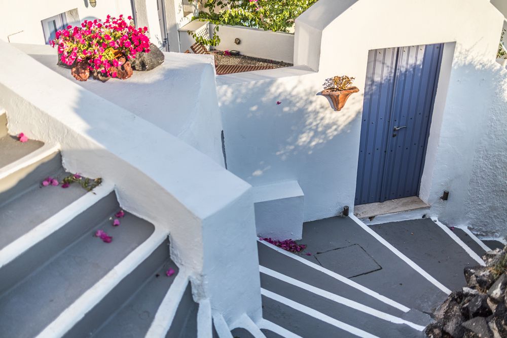 Stairwell leading to blue door in Greece