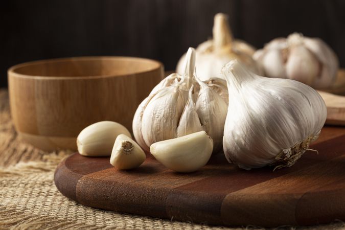 Garlic bulb and garlic cloves on the wooden table.