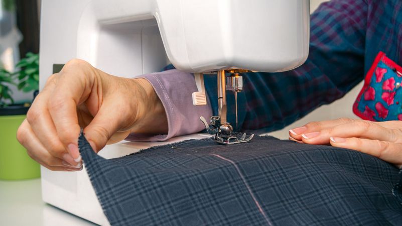 Seamstress hands working on a sewing machine