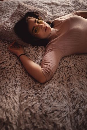 Young woman lying on bed