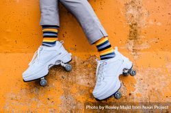 Person’e legs wearing colorful socks and roller skates 5R8pRb