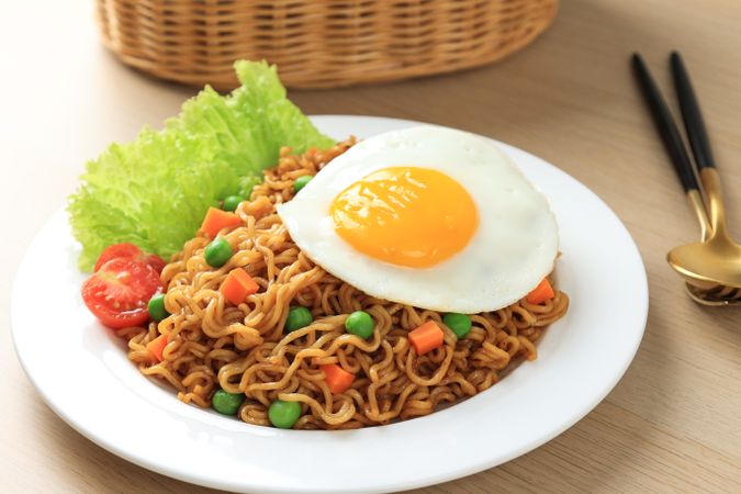 Close Up Indomie Goreng, Stir Fried Instant Noodles with Sunny Side Egg on Top.