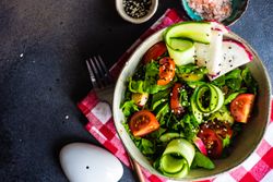 Healthy vegetable salad on rustic background with copy space