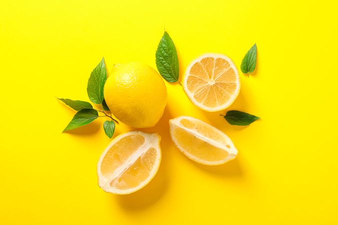 Flat lay composition with lemons on color background, space for text