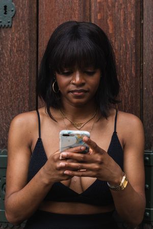 Black woman chatting on smartphone