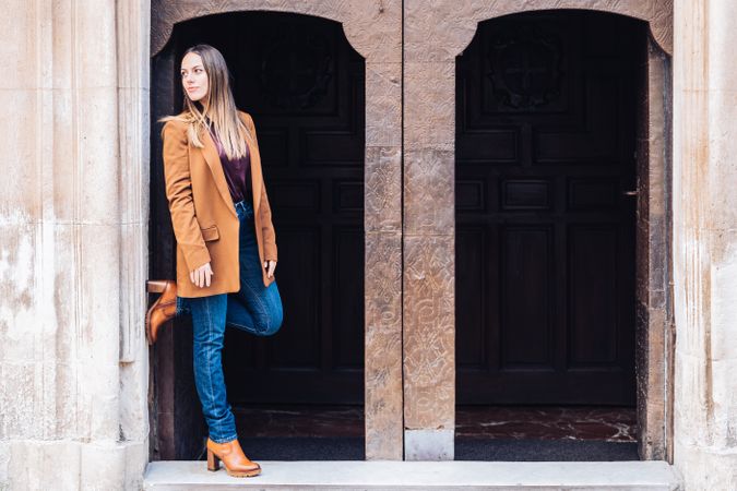 Pleased female in stylish outfit on street smiling away