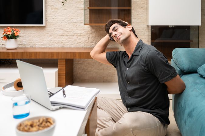 Man stretching while working from home