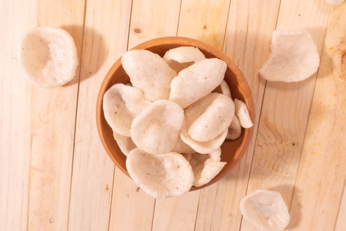 Crispy traditional crackers (kerupuk) served in a wooden bowl