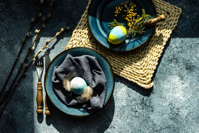 Top view of table setting with egg decorations and pussy willow
