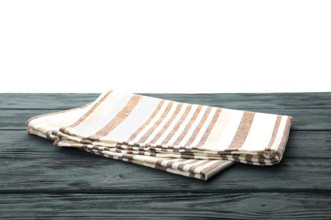 Fabric napkin on table against blank background, space for text