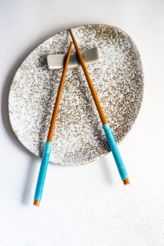 Asian style table setting with blue chop sticks