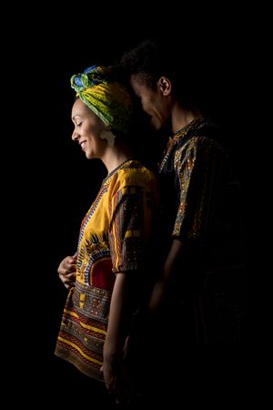 Couple of young Black people standing embracing