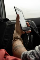 Man holding ebook in travel