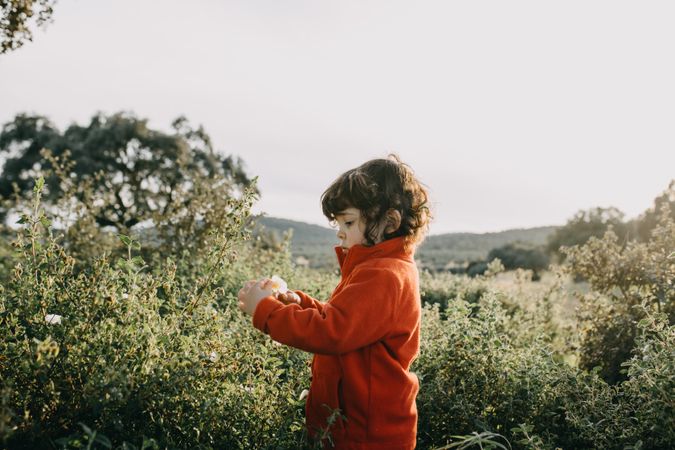 Young girl in red fleece in a park