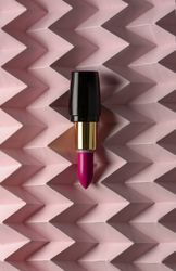 Lipstick on raised pink chevron. Product and make up concept