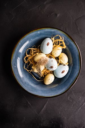 Rustic table setting with fresh eggs on navy plate