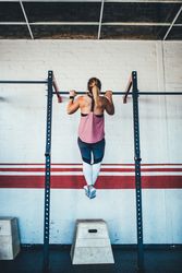 Woman doing a pull up in the gym