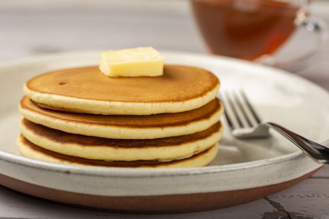 Delicious pancakes with butter and honey.
