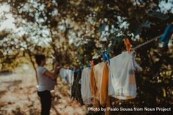 Woman hangs clothes to dry 41yag4