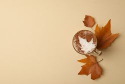 Composition with glass cup of latte on beige background