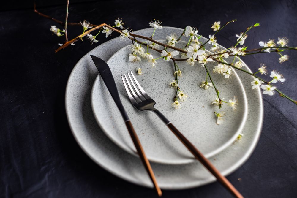 Spring table setting with blooming tree branch on plate
