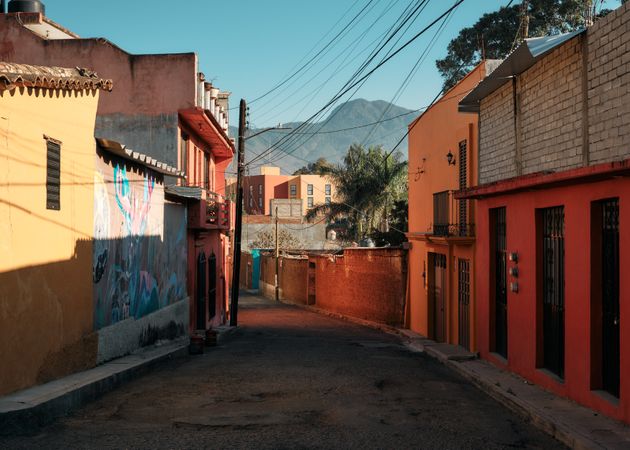 Empty colorful street in Oaxaca looking ahead to beautiful hills