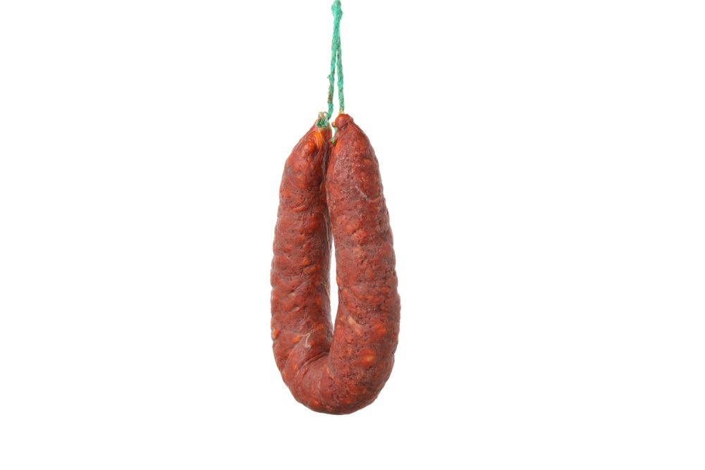 Cured chorizo suspended in blank room