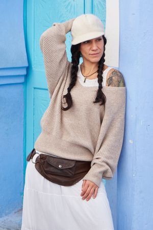 Smiling woman posing near vintage door