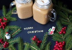 marshmellou hot cocoa trees in the background. The inscription Merry Christmas