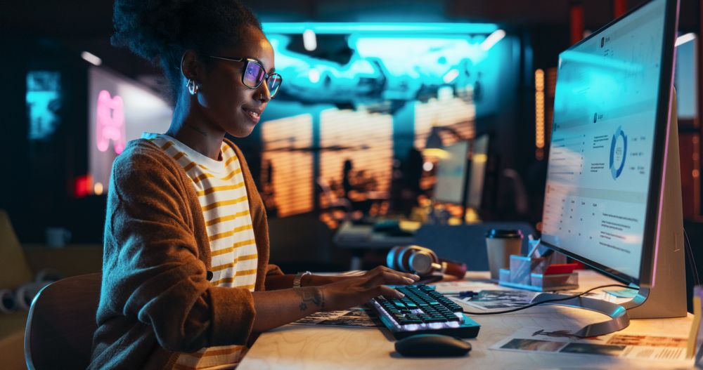Portrait of a Beautiful Happy Female Using Desktop Computer, Analysing Data, Thinking and Solving Problems.