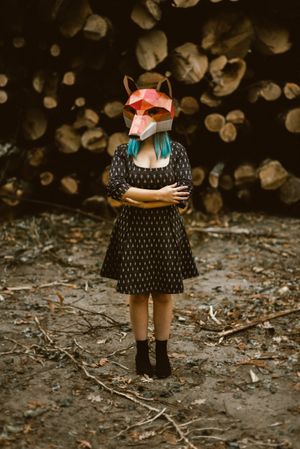 Enigmatic woman in red fox mask