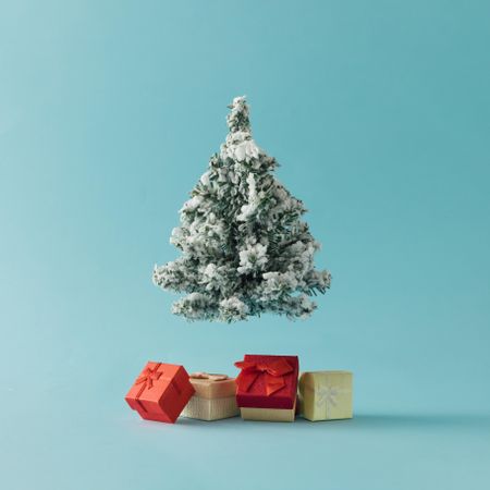 Christmas tree with gift boxes on bright blue background