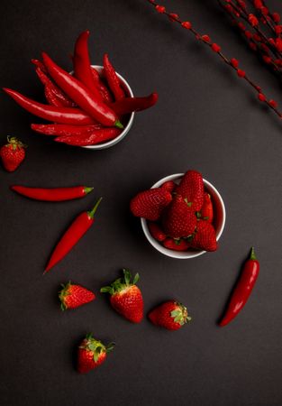 Cloth and branches near peppers and strawberries