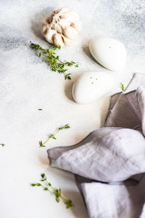Salt and pepper shakers and garlic bulb on marble background