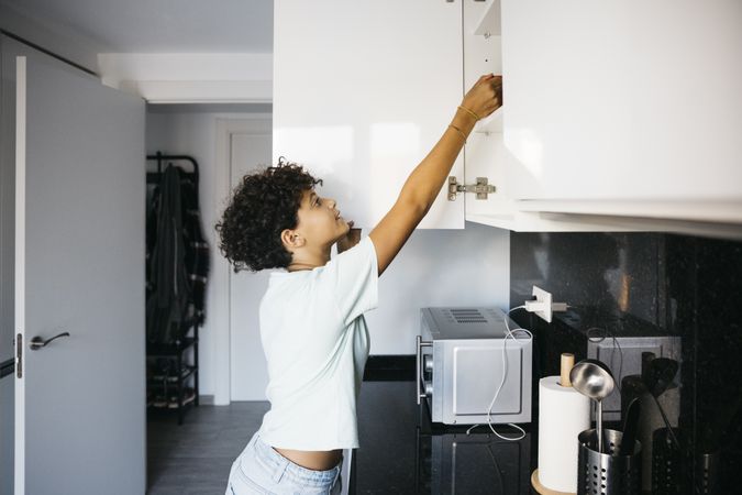 Girl preaparing a cup of milk