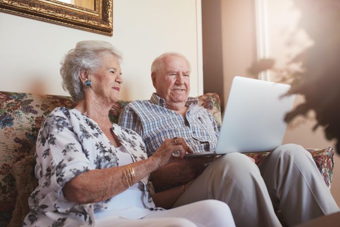 Older couple using laptop computer at home