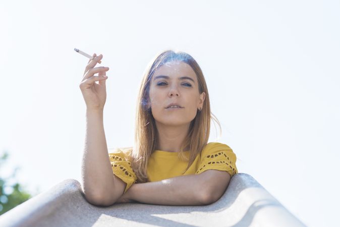 Young woman holding cigarette