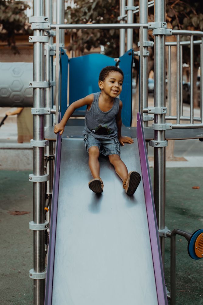 Smiling Black boy on slide
