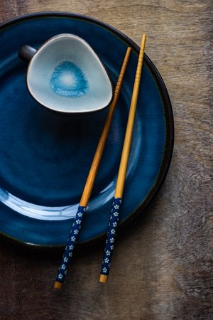 Asian table setting with ceramic plate and bowl with chopsticks