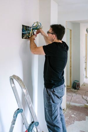 Electrician working on the electrical installation of a house