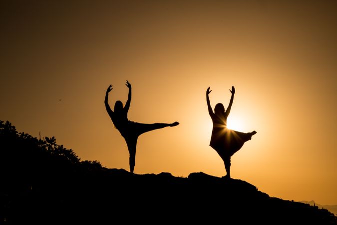 Women posing on hill in darkness