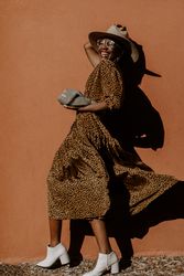 Woman wearing brown dress laughing