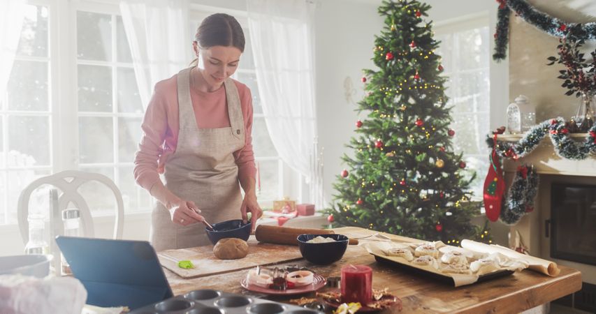 Portrait of Female Making Gingerbread Cookies for Christmas at Home.
