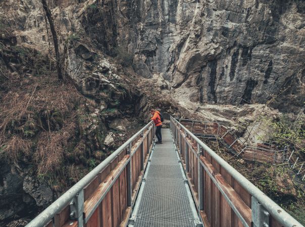 Tourist on hiking path among nature landscape